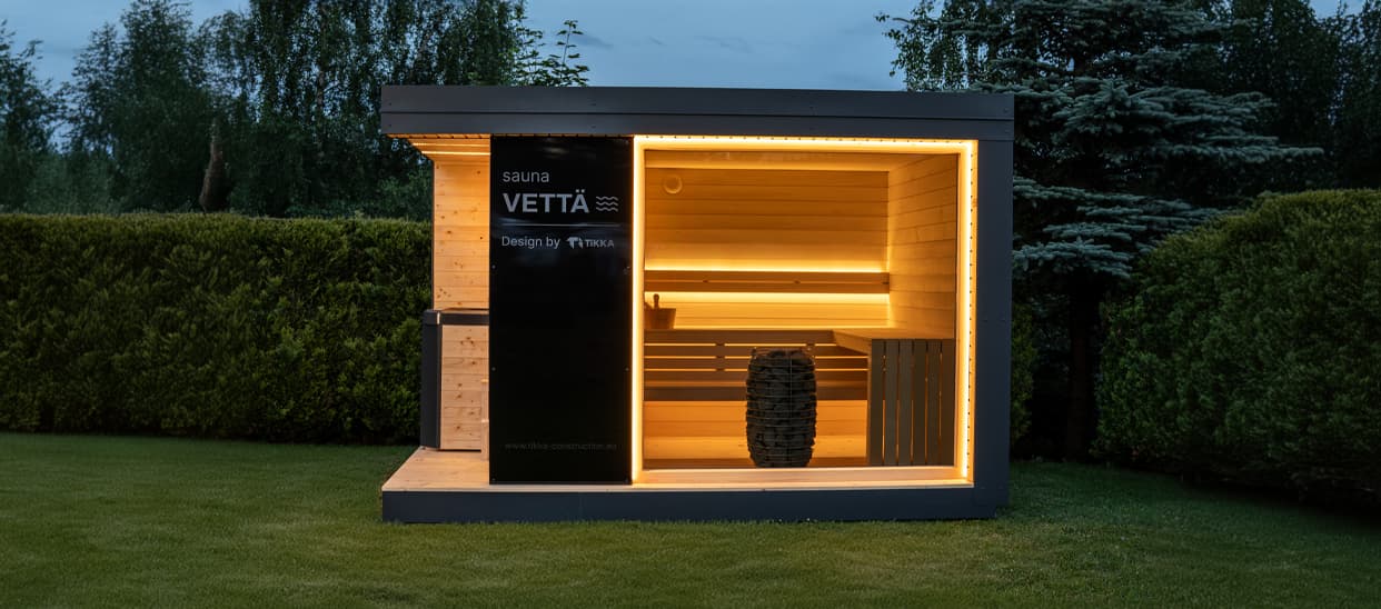 Vetta garden sauna at dusk in a Bavarian garden with the interior lit
